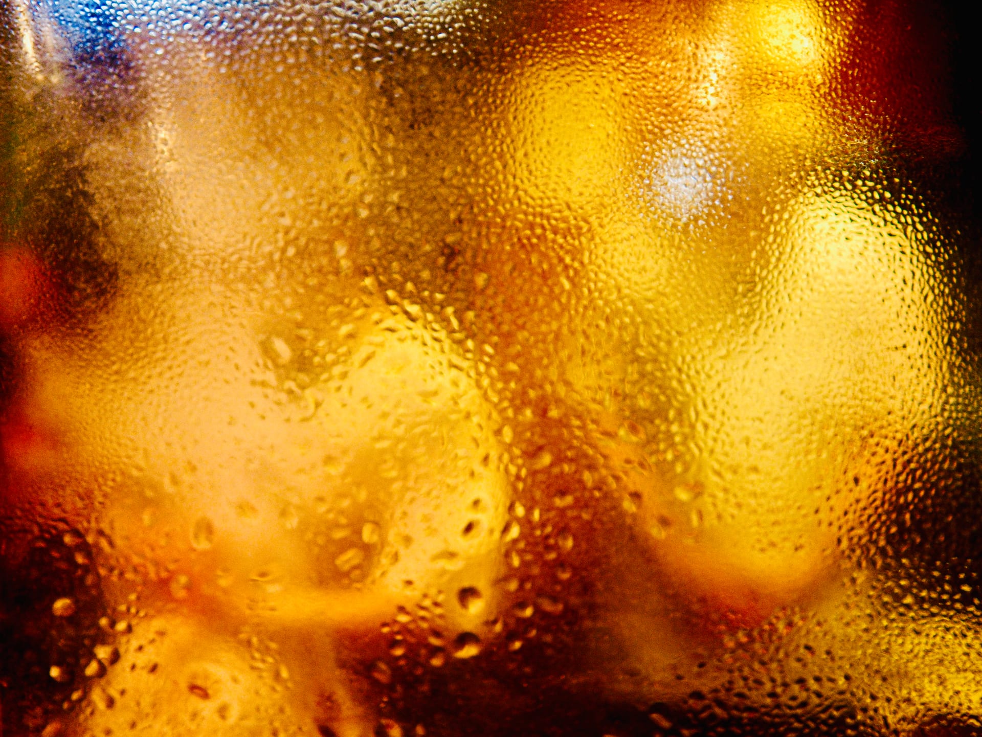 Amber light through condensation on glass, by Erik Hadife.